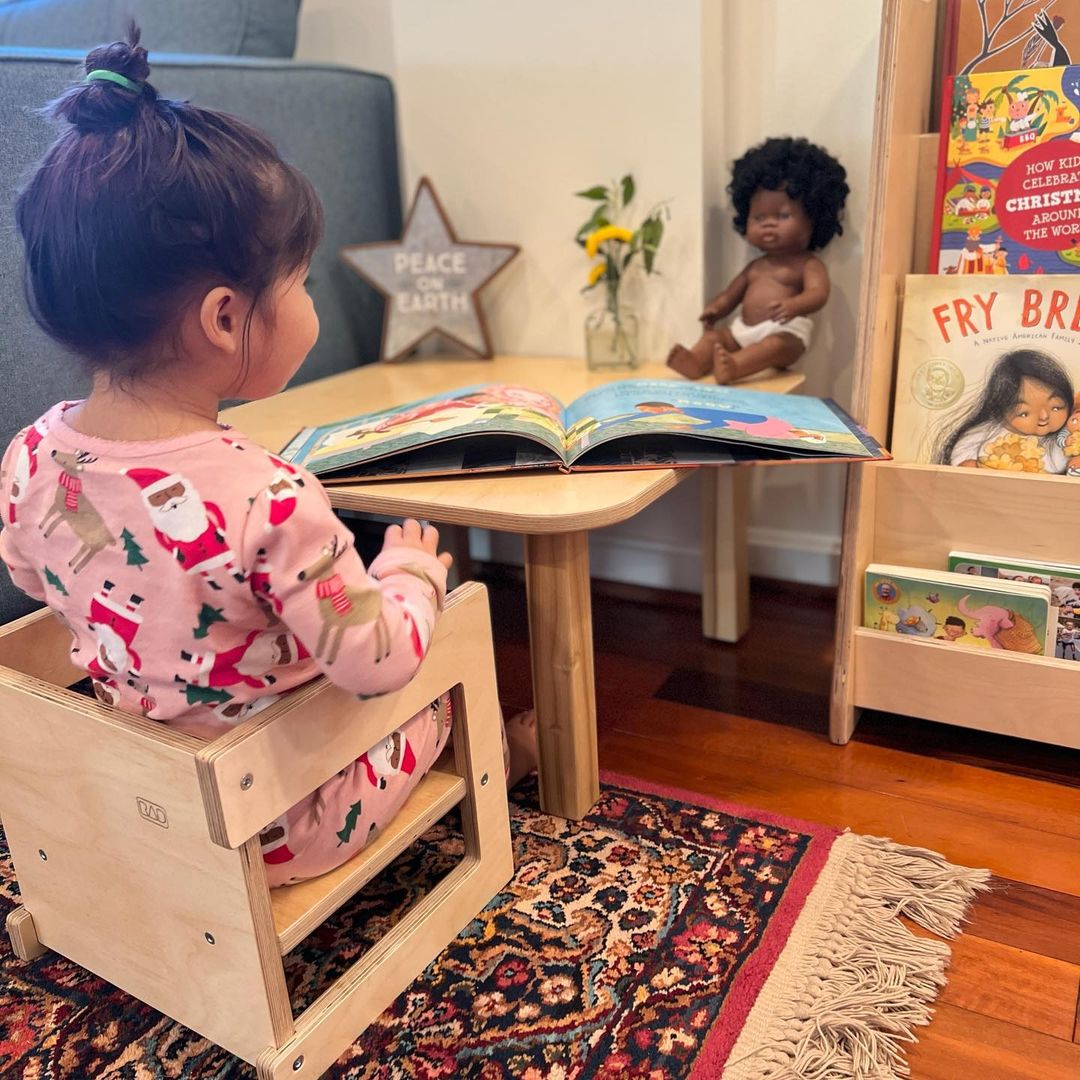 Girl reading on a Montessori Cube Chair