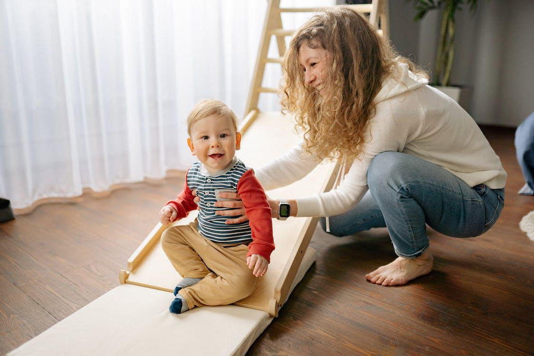 How does a parent help a child use a pikler triangle?  By supporting them as they explore it