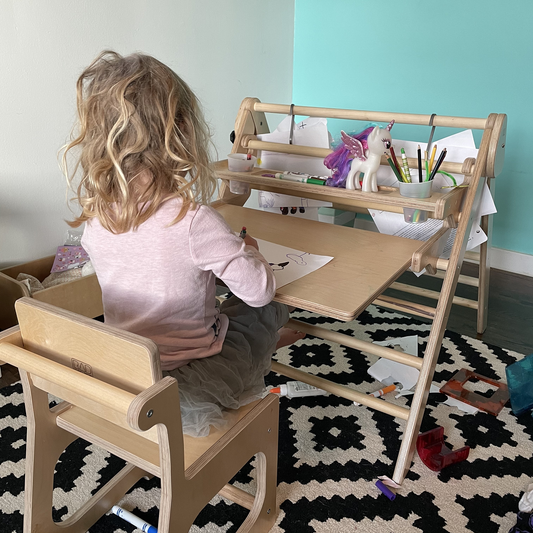 child using pikler triangle attachment desk
