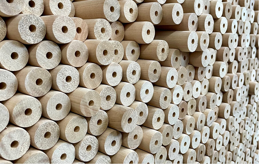 Stack of wooden spools with uniform circular holes