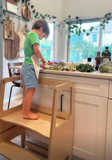 A child using the toddler learning tower