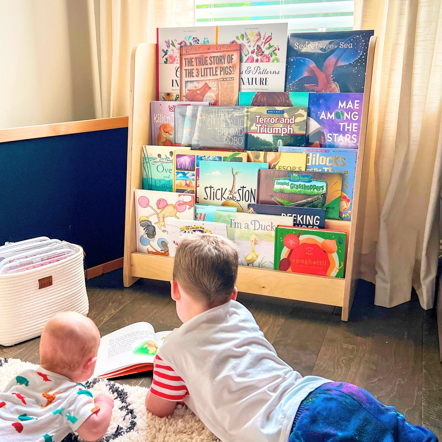 children reading from montessori bookshelf