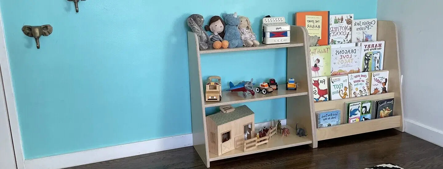 Children's bookshelf with toys and books against a blue wall