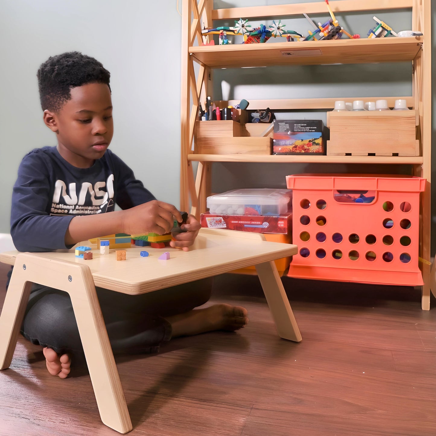 chowki table with kindergarten aged child working on legos