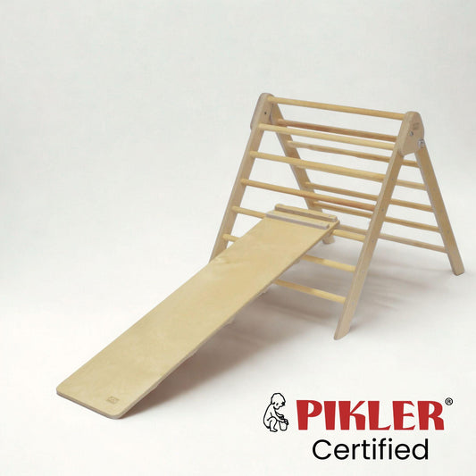 Short climbing board on pikler triangle. Wooden Montessori climber.