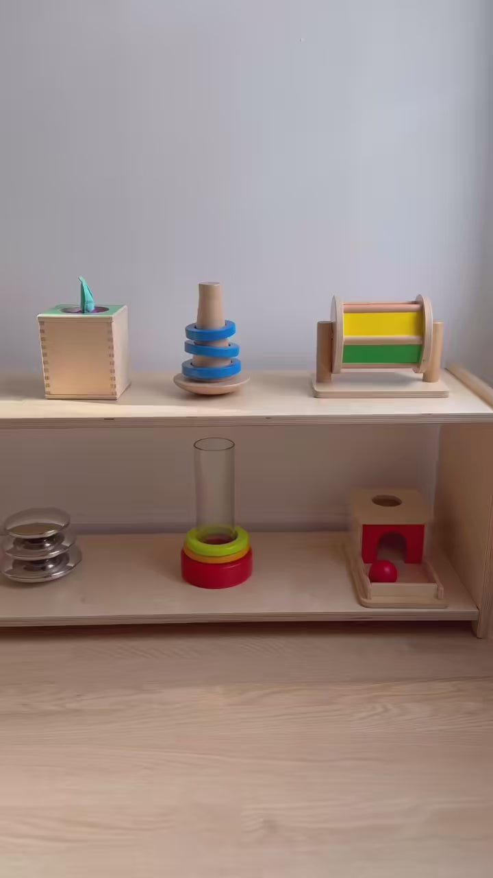 montessori shelf for infants with montessori toys on it