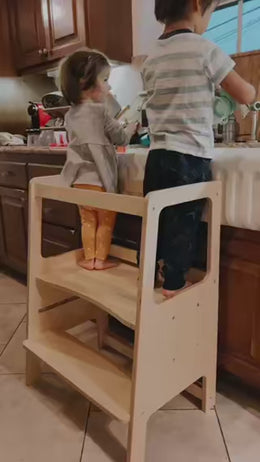 children in kitchen washing dishes on kitchen helper