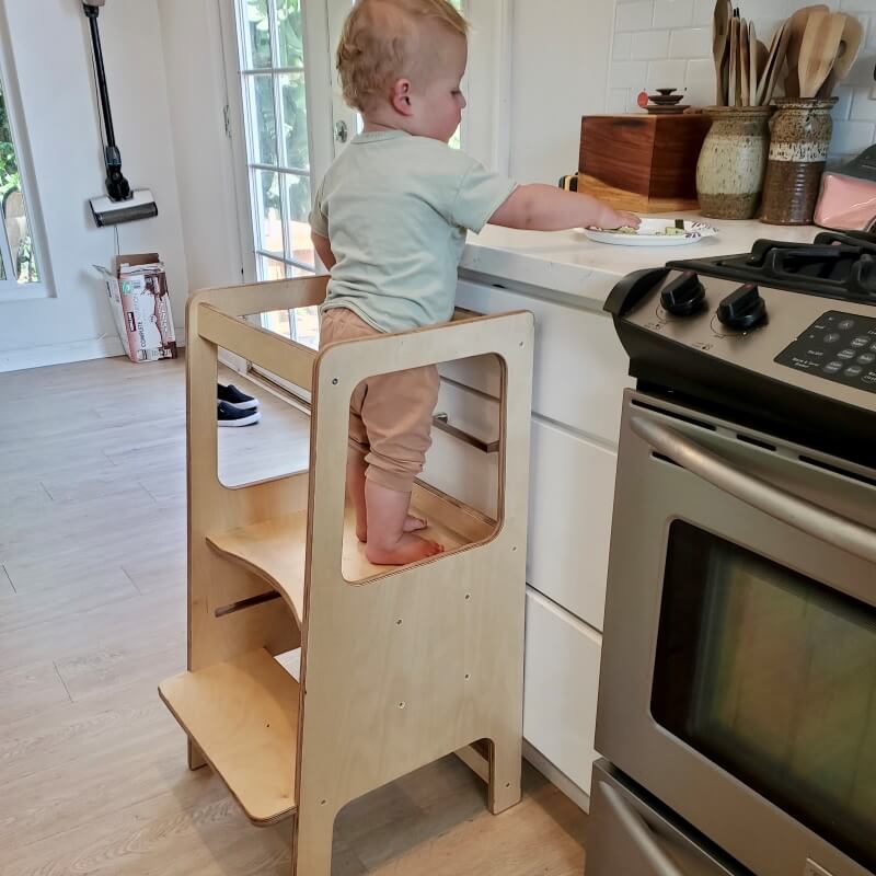 toddler working in kitchen in a learning tower