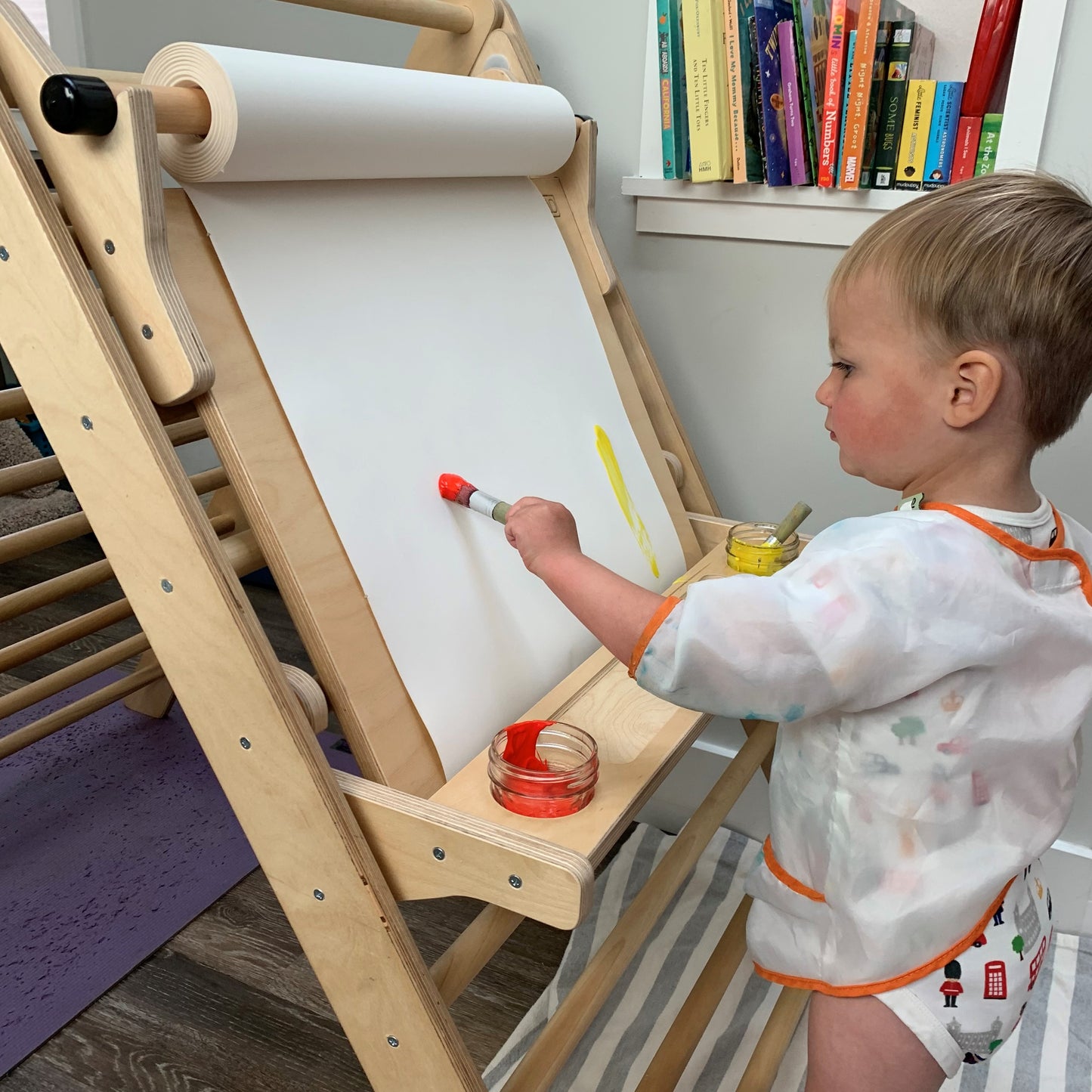 pikler triangle easel attachment being painted on