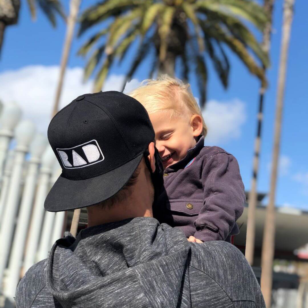 Dad wearing a RAD hat with child