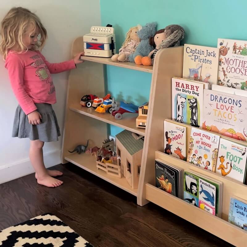 child choosing toys on montessori toy shelf