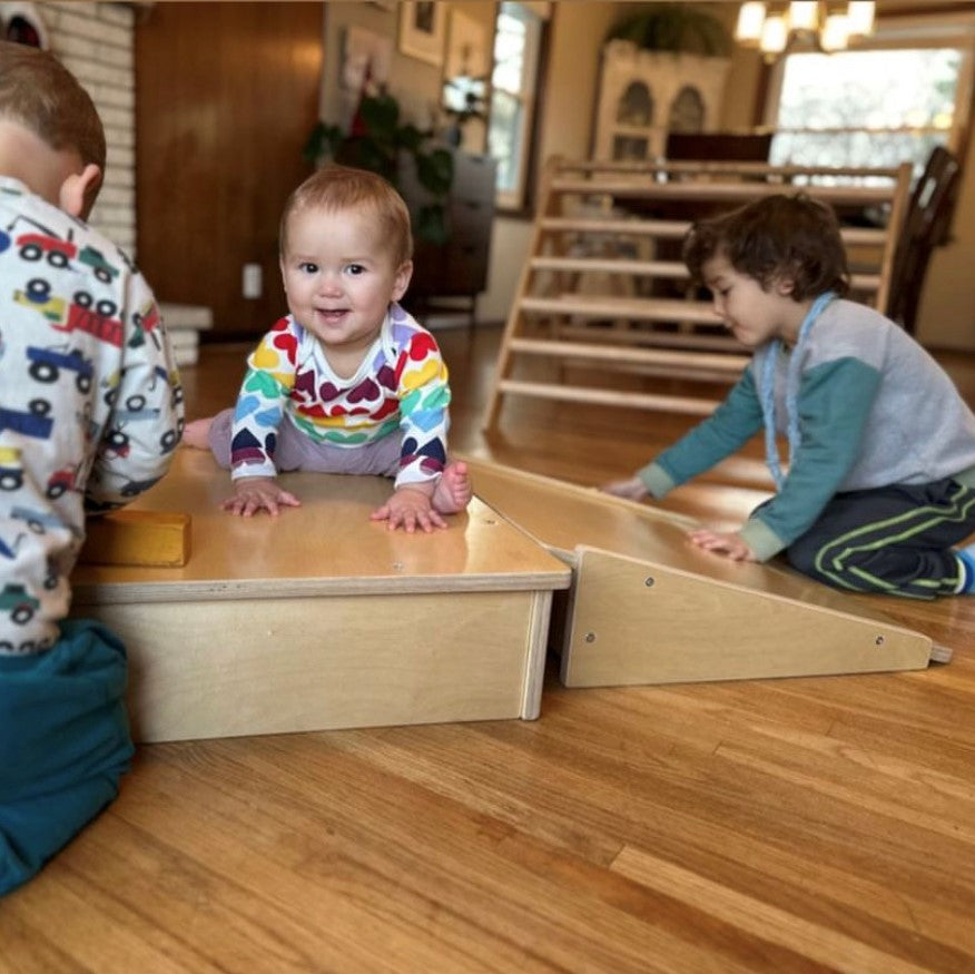 pikler platform with baby learning to crawl